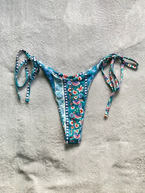 Teal Floral Pattern Side Tie Bikini Bottom (Category: Bikinis & Swimsuits) located in Rizal. Submitted by sheeraay (Listing ID 1467649647, Image 2). Description: - Teal bikini bottom with colorful floral and paisley print - Adjustable side ties on both hips for a custom fit - Low-rise cut with cheeky coverage - Trendy ribbed fabric texture.
