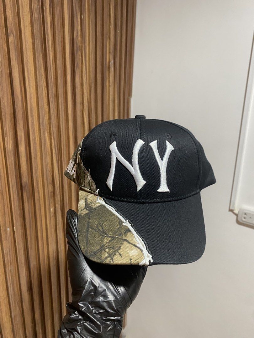 The Museum Visitor NY Camo Cap (Category: Caps & Hats) located in Caloocan City. Submitted by heatedcaps4425 (Listing ID 1467801785, Image 2). Description: - Brand: The Museum Visitor Boutique House - Design: Black and camo paneling with distressed white stitching - Details: Embroidered white NY logo on front and OMA lettering on the side - Material: 100 percent cotton (hand wash only) - Condition: Clean interior with brand tags intact - Style: G