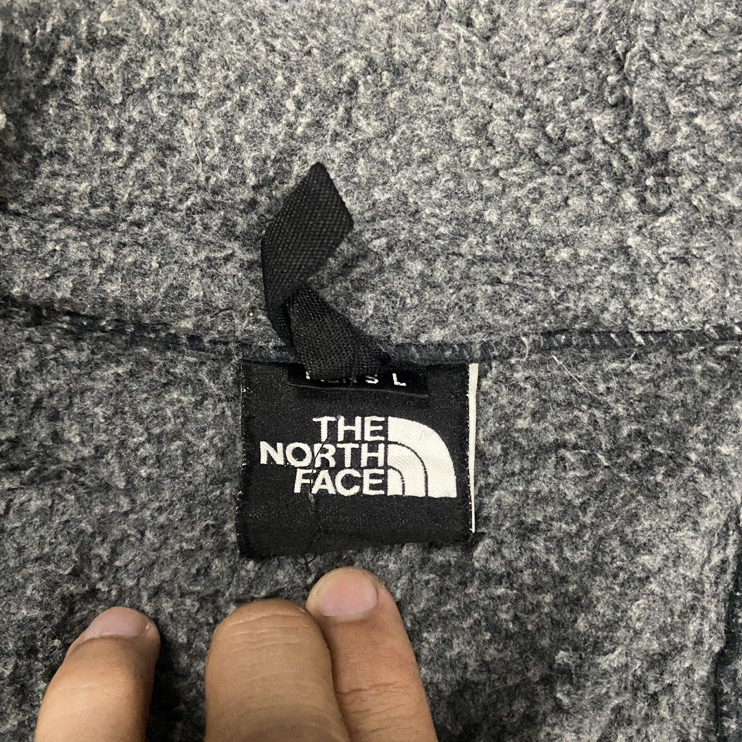 The North Face Grey Fleece Jacket (Category: Coats, Jackets and Outerwear) located in Santa Maria. Submitted by saintarchive316 (Listing ID 1467836804, Image 3). Description: Grey fleece zip-up jacket from The North Face. Men's size large tag attached at the collar. Full zip front closure with additional vertical chest pocket and two lower hand pockets. Dark grey embroidered branding on the upper chest. Interior tags include Japanese care instruc