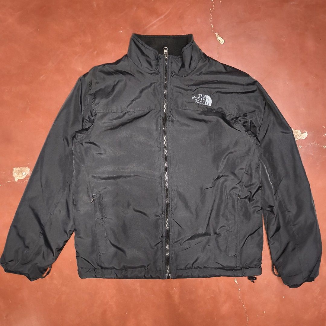 The North Face Reversible Black Jacket (Category: Coats, Jackets and Outerwear) located in Antipolo. Submitted by alphaomega_fox (Listing ID 1467705851, Image 1). Description: - Brand: The North Face - Color: Classic Black - Design: Reversible (Smooth fabric on one side, cozy fleece on the other) - Closure: Full front zip with high wind-blocking collar - Pockets: Secure zippered pockets on the smooth side - Fit: Adjustable hem with drawcords for 