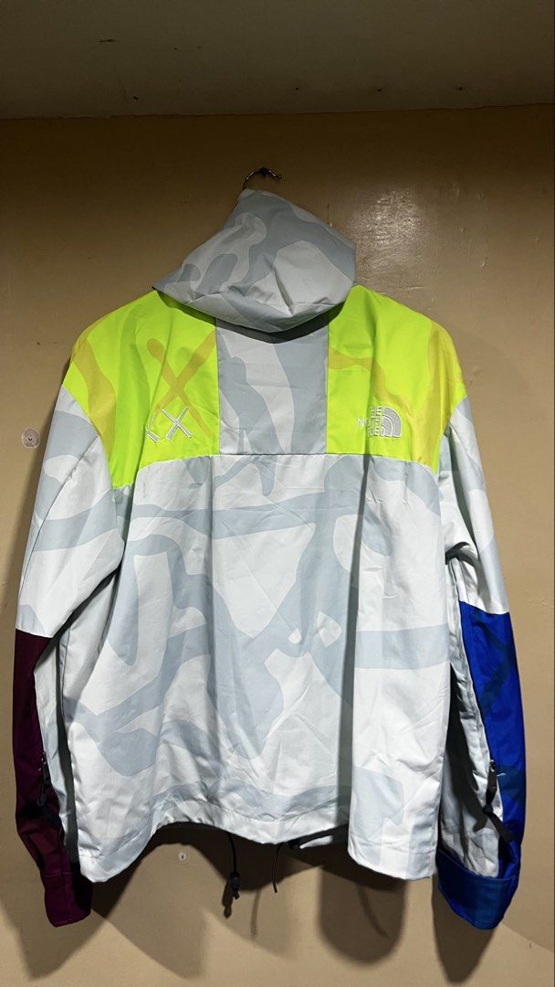 The North Face x KAWS Retro 1994 Mountain Light Jacket (Category: Coats, Jackets and Outerwear) located in Tacloban City. Submitted by rxluminoque (Listing ID 1467723155, Image 3). Description: - Authentic The North Face x KAWS collaboration jacket - Eye-catching multi-color print with neon yellow shoulders - Contrasting blue and maroon sleeve cuffs - Hooded design with adjustable drawstrings and snap button front closure - Size: US Small / Asia 