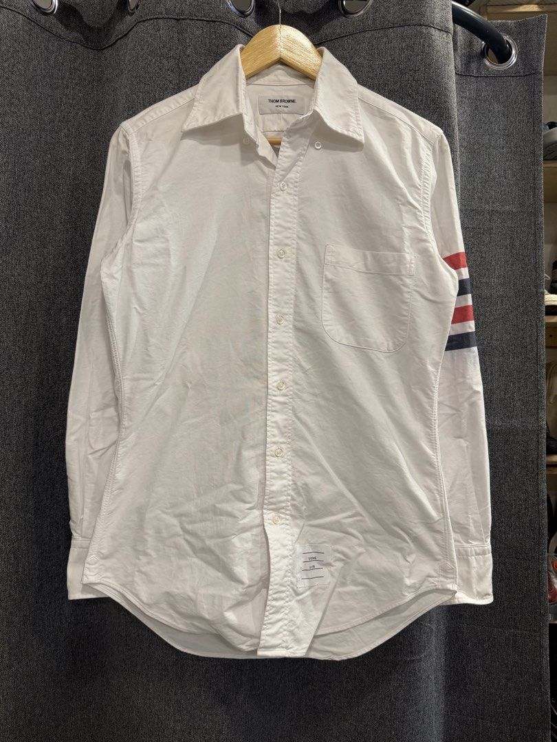 Thom browne (Category: Tshirts & Polo Shirts ) located in Quezon City. Submitted by macleen17 (Listing ID 1467663518, Image 1). Description: Thom browne Size 1 Dimes 19.5W/29L Issue Color stain in iconic Design Excellent Condition White color .