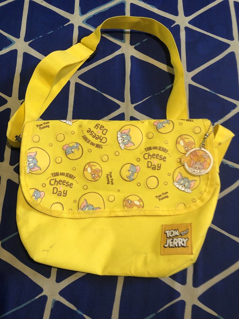 Tom and Jerry sling bag (Category: Shoulder Bags) located in Quezon City. Submitted by markgolveo (Listing ID 1467670235, Image 1). Description: Tom and Jerry sling bag Good zippers and pockets Minor signs of weas Just needed a bit of cleaning.