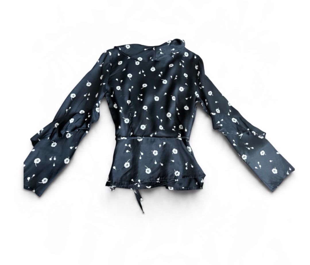 TOPSHOP Black Floral Wrap Blouse (Category: Blouses) located in Makati City. Submitted by beehive03 (Listing ID 1463572881, Image 3). Description: - Cute black wrap blouse - White floral print - Ruffle details on sleeves and neckline - Tie waist for adjustable fit -nice fabric .