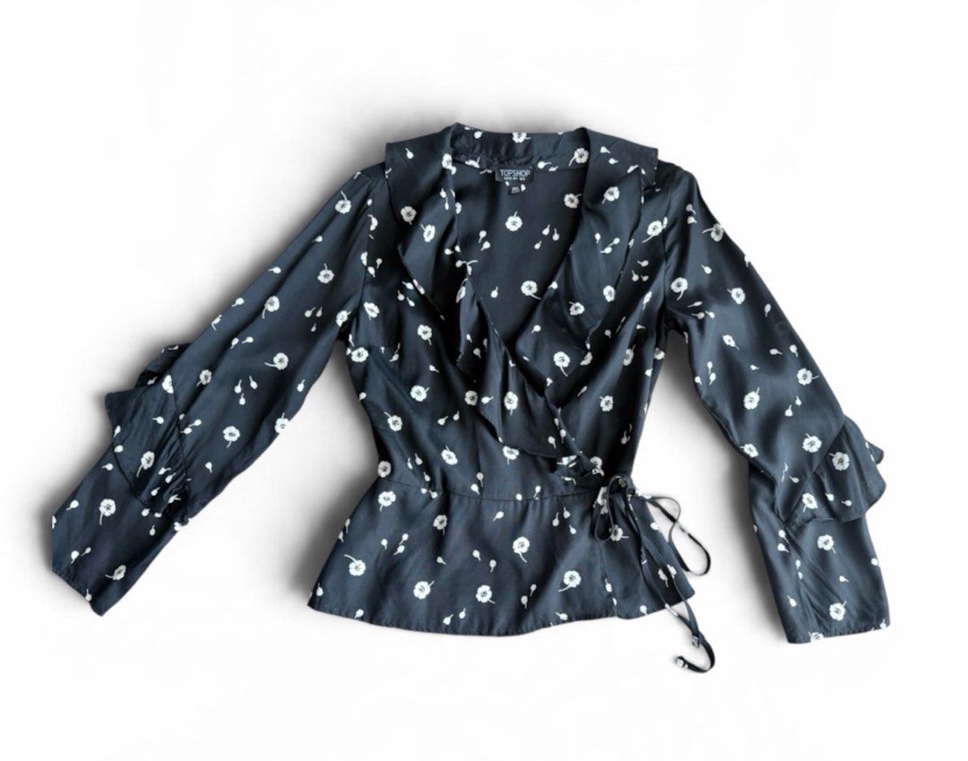 TOPSHOP Black Floral Wrap Blouse (Category: Blouses) located in Makati City. Submitted by beehive03 (Listing ID 1463572881, Image 1). Description: - Cute black wrap blouse - White floral print - Ruffle details on sleeves and neckline - Tie waist for adjustable fit -nice fabric .
