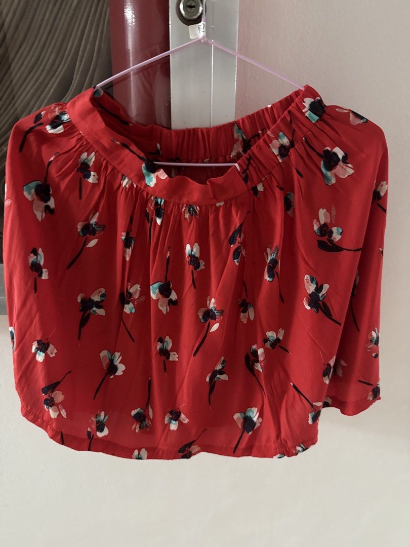 Topshop Red Floral Skirt (Category: Blouses) located in Mandaluyong City. Submitted by declutteringmylife101 (Listing ID 1467681676, Image 1). Description: - Color/Pattern: Bright red with all-over blue and pink floral print - Fit: Short, loose, and easy pullover style - Neckline: Gathered elastic for comfort - Sleeves: Trendy flared design - Fabric: Lightweight and breezy for everyday wear.