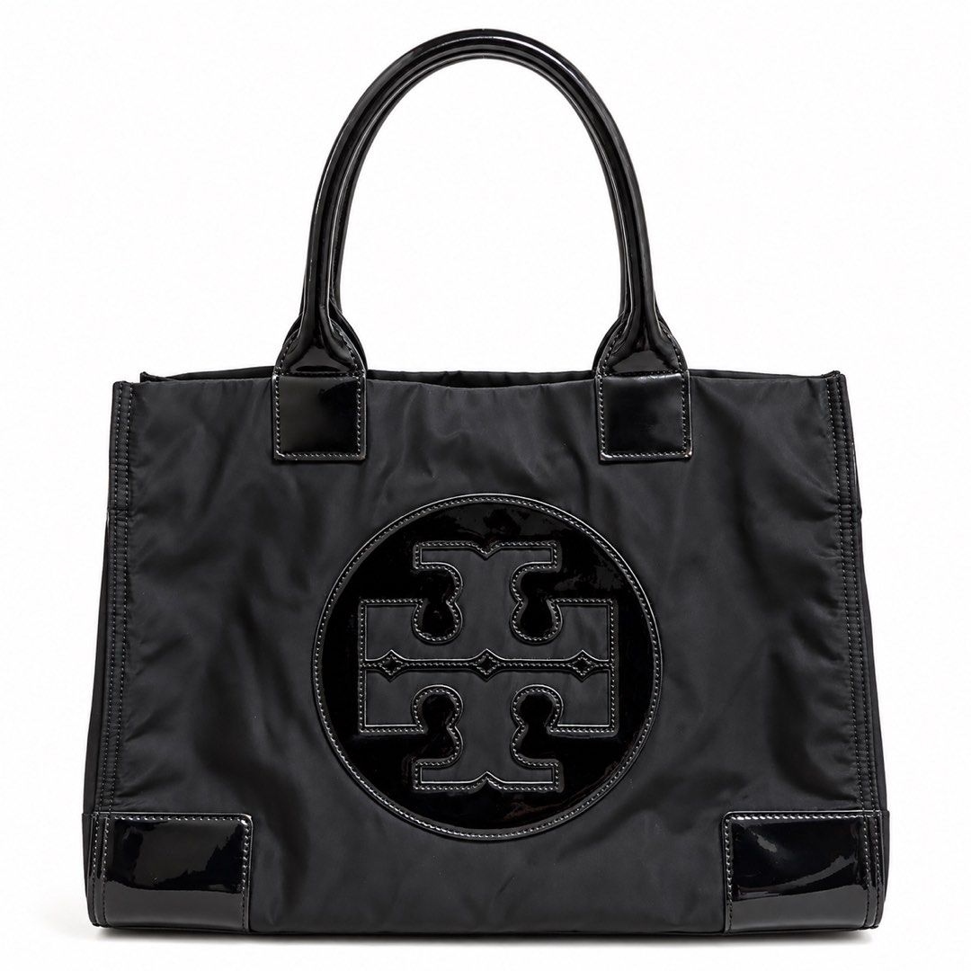 Tory Burch Black Nylon Tote Bag (Category: Tote Bags) located in Tarlac. Submitted by kayeshe (Listing ID 1467740073, Image 1). Description: - 100% authentic - Material: Durable black nylon with patent leather trim and handles - Features: Large patent leather front logo, magnetic top snap closure - Interior: Beige fabric lining with a zippered pocket and metal logo plaque - Condition: Roomy everyday bag with minor wear on patent trim corners.