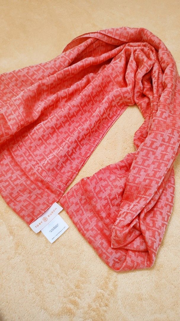 Tory Burch Monogram Scarf Coral Pink (Category: Scarves) located in Manila. Submitted by anez06 (Listing ID 1467613726, Image 2). Description: - Brand: Tory Burch - Color: Bright coral pink with all-over monogram pattern - Material: Soft viscose and modal blend (Made in Italy) - Features: Lightweight fabric, perfect for draping over coats or wearing on cooler days - Condition: Brand tag and care label attached.