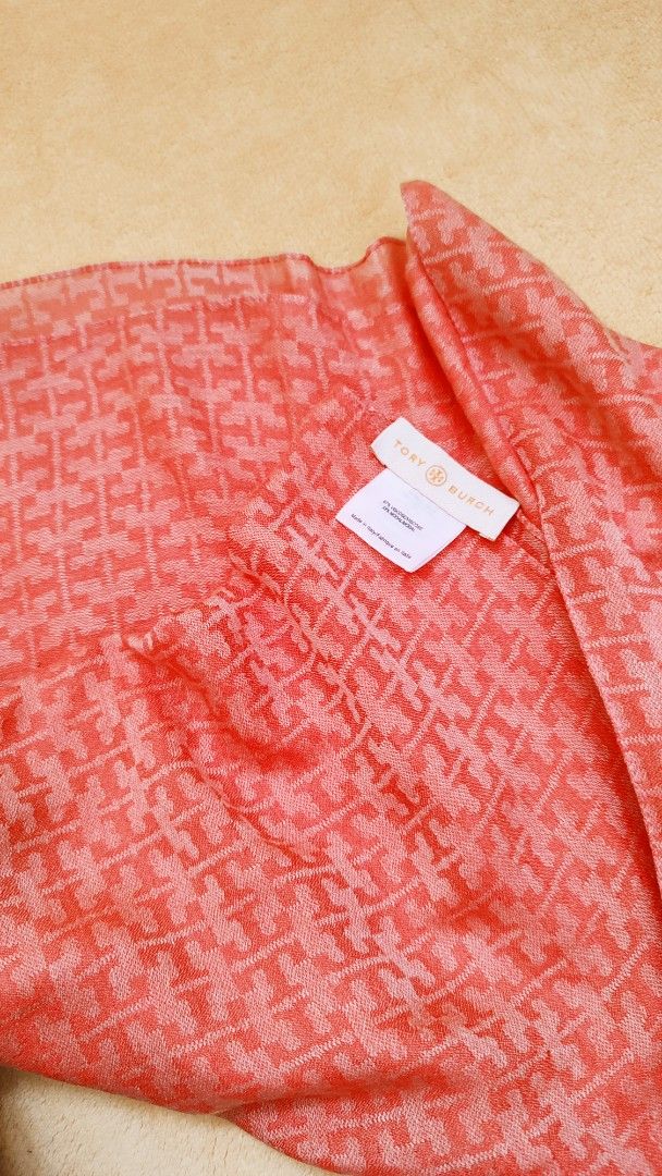 Tory Burch Monogram Scarf Coral Pink (Category: Scarves) located in Manila. Submitted by anez06 (Listing ID 1467613726, Image 1). Description: - Brand: Tory Burch - Color: Bright coral pink with all-over monogram pattern - Material: Soft viscose and modal blend (Made in Italy) - Features: Lightweight fabric, perfect for draping over coats or wearing on cooler days - Condition: Brand tag and care label attached.