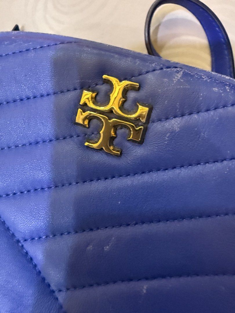 Tory Burch Quilted Blue Crossbody Bag (Category: Cross-body Bags) located in Manila. Submitted by missgrace_collection (Listing ID 1467634920, Image 2). Description: - Brand: Tory Burch - Style: Chevron quilted leather crossbody bag - Color: Bright blue with gold-tone hardware and classic double T logo - Closure: Zip-top - Interior: Cream patterned fabric lining with brand plaque - Condition: Pre-loved with visible scuffs/wear along edges and pip