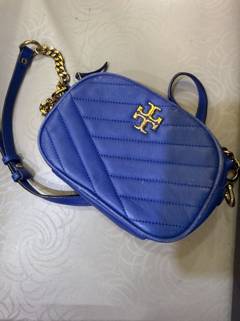 Tory Burch Quilted Blue Crossbody Bag (Category: Cross-body Bags) located in Manila. Submitted by missgrace_collection (Listing ID 1467634920, Image 1). Description: - Brand: Tory Burch - Style: Chevron quilted leather crossbody bag - Color: Bright blue with gold-tone hardware and classic double T logo - Closure: Zip-top - Interior: Cream patterned fabric lining with brand plaque - Condition: Pre-loved with visible scuffs/wear along edges and pip