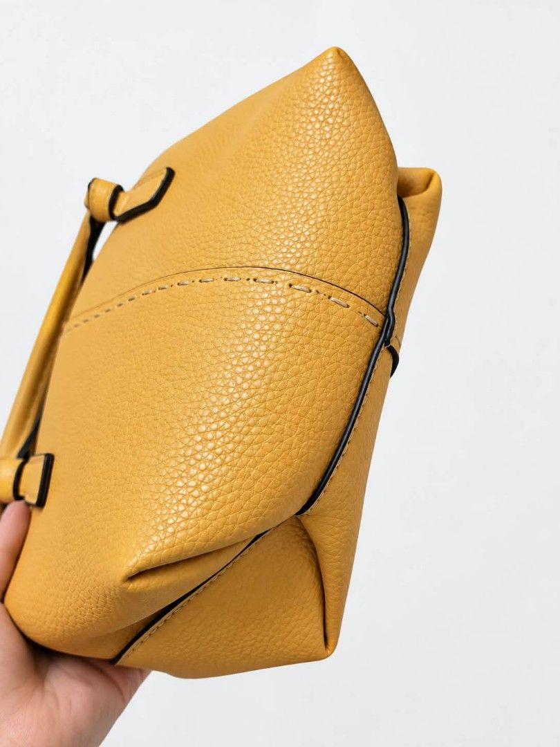 TORY BURCH Mcgraw mini satchel handbag (Category: Tote Bags) located in Lucena. Submitted by amirahsoonlineshop (Listing ID 1467650993, Image 3). Description: - Material: Vibrant yellow pebbled leather with black edge coating - Design: Twin top handles, contrast center stitching, and gold-tone T logo emblem on front - Interior: Clean lining with tag reading Made in China HKF001 11-14 - Condition: Well-maintained and ready to use.
