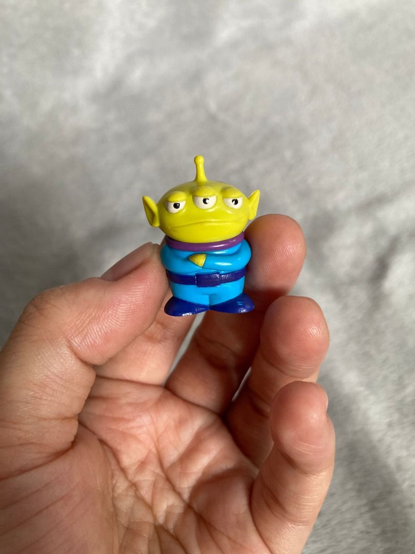 Toy Story Alien Mini Figure (Category: Figurines & Statues) located in Rizal. Submitted by sheeraay (Listing ID 1467707134, Image 3). Description: - Genuine Toy Story Alien figurine - Features a blue suit and yellow head - Comes with original sticker on the back - Compact size, ideal for desk setups or shelf displays.