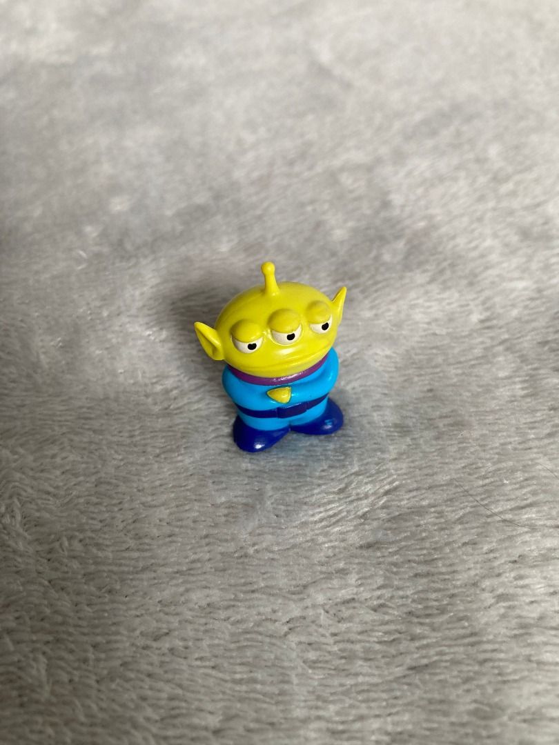 Toy Story Alien Mini Figure (Category: Figurines & Statues) located in Rizal. Submitted by sheeraay (Listing ID 1467707134, Image 1). Description: - Genuine Toy Story Alien figurine - Features a blue suit and yellow head - Comes with original sticker on the back - Compact size, ideal for desk setups or shelf displays.