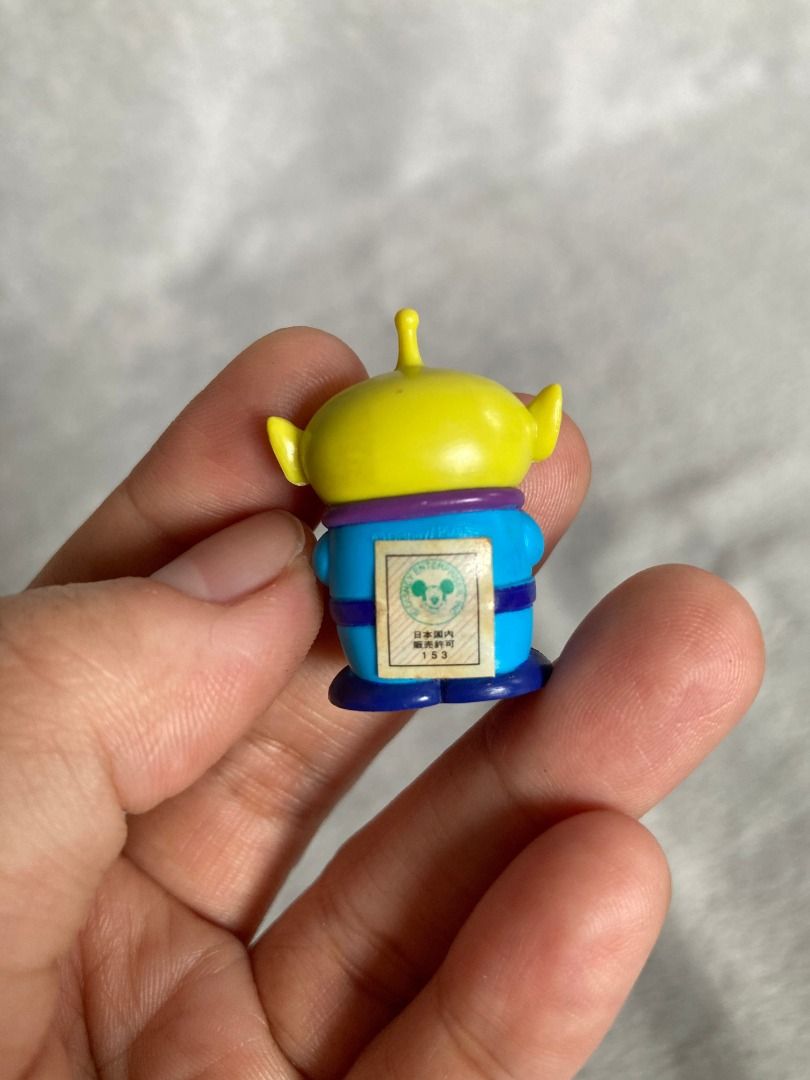Toy Story Alien Mini Figure (Category: Figurines & Statues) located in Rizal. Submitted by sheeraay (Listing ID 1467707134, Image 2). Description: - Genuine Toy Story Alien figurine - Features a blue suit and yellow head - Comes with original sticker on the back - Compact size, ideal for desk setups or shelf displays.