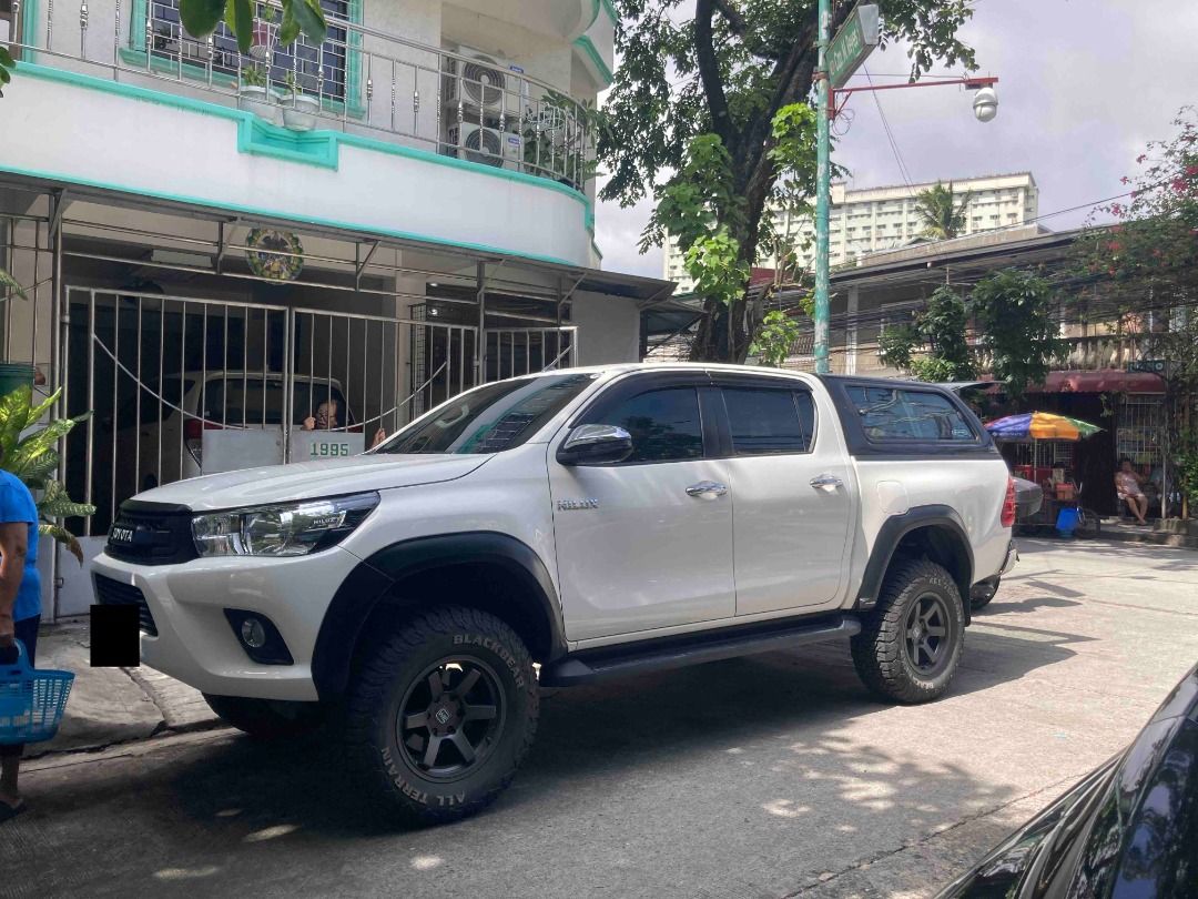 Toyota Hilux Auto (Category: Used Cars) located in Taguig. Submitted by paulvp_s (Listing ID 1467717166, Image 2). Description: Toyota Hilux (Revo) G variant 4x2 Freedom White color 2.4 Turbo Diesel Automatic Transmission 76,000 km mileage Leather seats with embroidered Toyota logo With front and back camera 4-inch lift by Ironman with add a leaf Front shock absorber - Old Man Emu Rear shock absorber - Ironman Black Mamba Mags Black Bear All Terr