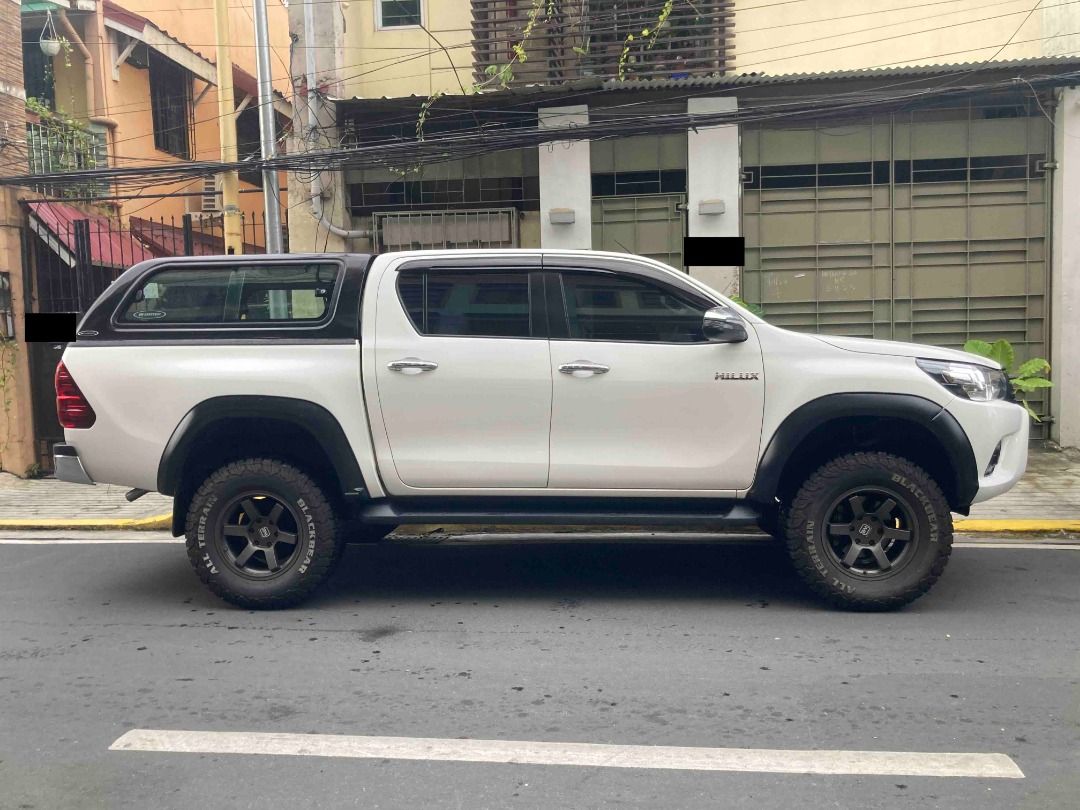 Toyota Hilux Auto (Category: Used Cars) located in Taguig. Submitted by paulvp_s (Listing ID 1467717166, Image 3). Description: Toyota Hilux (Revo) G variant 4x2 Freedom White color 2.4 Turbo Diesel Automatic Transmission 76,000 km mileage Leather seats with embroidered Toyota logo With front and back camera 4-inch lift by Ironman with add a leaf Front shock absorber - Old Man Emu Rear shock absorber - Ironman Black Mamba Mags Black Bear All Terr
