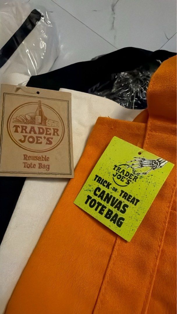 Trader Joe's Official Canvas Tote Bag (Category: Tote Bags) located in Quezon City. Submitted by imcandycloset (Listing ID 1467725967, Image 3). Description: - 100% Authentic Trader Joe's canvas tote bag, imported straight from the US - Brand new, in original packaging with tags attached - Made from durable, heavy-duty canvas material - Features classic navy blue straps/bottom and the iconic red logo stamp - Versatile and spacious: perfect for gr
