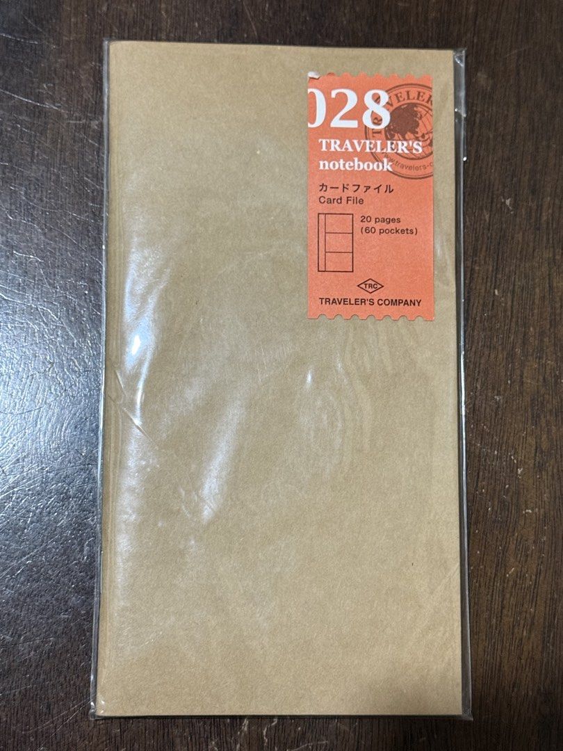 Traveler's Notebook Refill Card File 028 (Category: Stationery & School Supplies) located in Pasig City. Submitted by boredtakoyaki (Listing ID 1467713218, Image 1). Description: - Brand: Traveler's Company (Made in Japan) - Item: 028 Card File Refill - Condition: Brand new, unopened in original packaging with barcode sticker - Capacity: 20 pages with 60 total card pockets - Details: Kraft paper cover with brown sticker label.