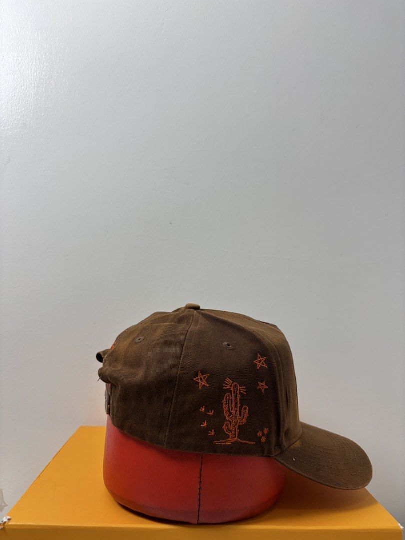 Travis Scott Astroworld Brown Snapback Cap (Category: Caps & Hats) located in Marikina City. Submitted by zaxcheus_castillo1708 (Listing ID 1467654163, Image 3). Description: - Official Travis Scott merchandise brown corduroy cap - Front: White Houston H logo with red star backing - Left side: Cactus and star embroidery - Right side: Monogram design - Back: Signature script embroidery above the opening - Closure: Adjustable brown snapback - Perfe