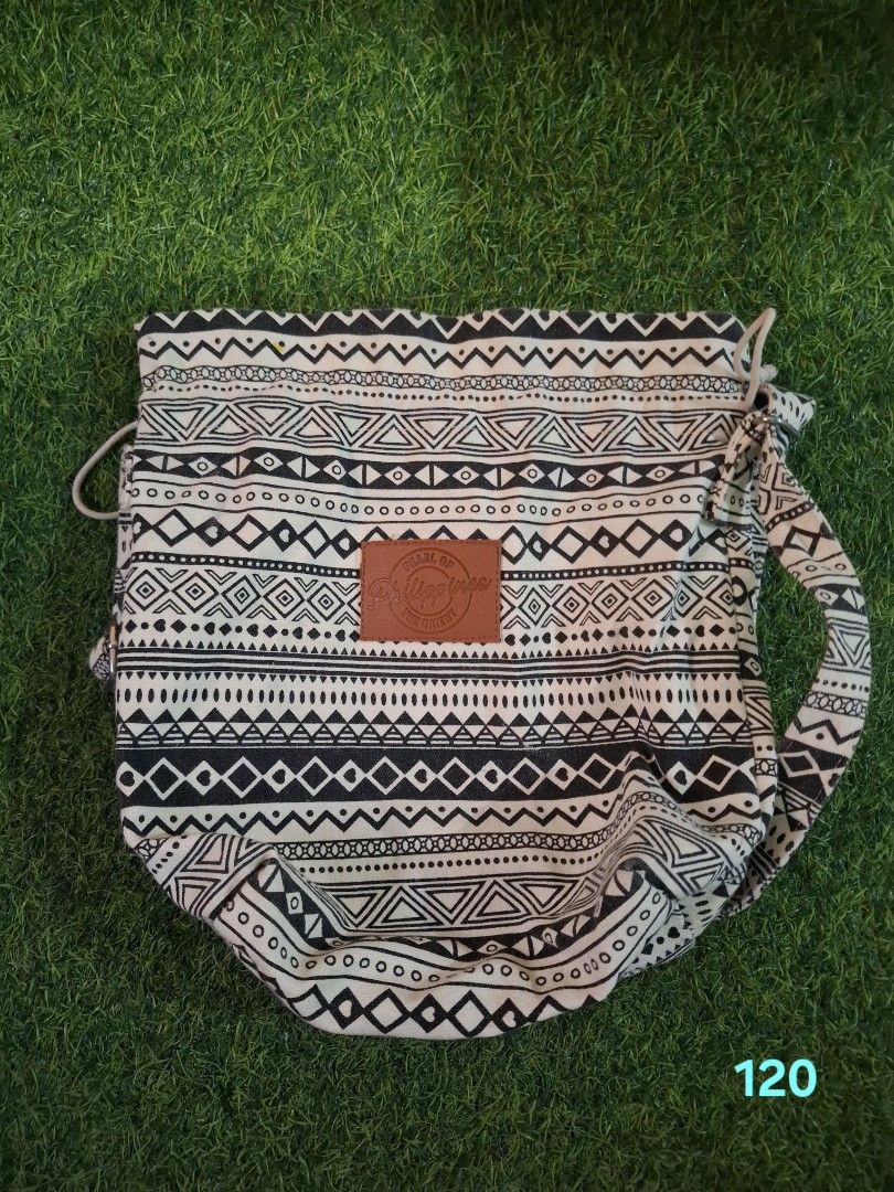 Tribal Print Black and White Drawstring Shoulder Bag (Category: Shoulder Bags) located in Pasay City. Submitted by emilia1102 (Listing ID 1467795801, Image 2). Description: - Style: Casual shoulder bag with classic black and white tribal geometric print - Closure: Secure top drawstring - Strap: Adjustable for comfortable wear - Details: Brown leather patch stamped with 'Pearl of the Philippines' - Material: Lightweight fabric - Size: Ideal for da