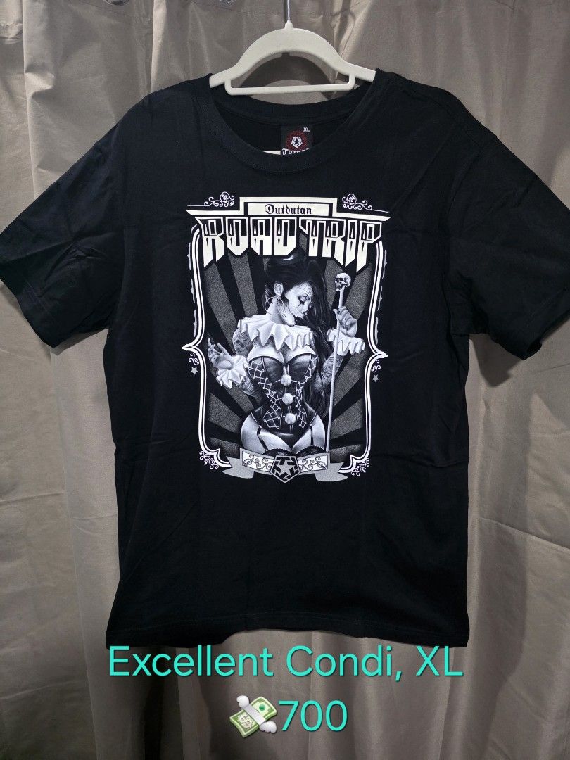 Tribal Road Trip XL (Category: Tshirts & Polo Shirts ) located in Santa Rosa. Submitted by rowhell09 (Listing ID 1467777466, Image 1). Description: Dutdutan Road Trip XL, Excellent Condi 💸700 MOD. LBC MOP. BDO, GCASH LOC. NUEVA ECIJA Meet up. Santa rosa Nueva Ecija - Color: Black - Design: Front features a detailed black & white clown girl holding a skull wand; small tribal star logo near the back collar - Fit: Short sleeves, crew neck - Conditi