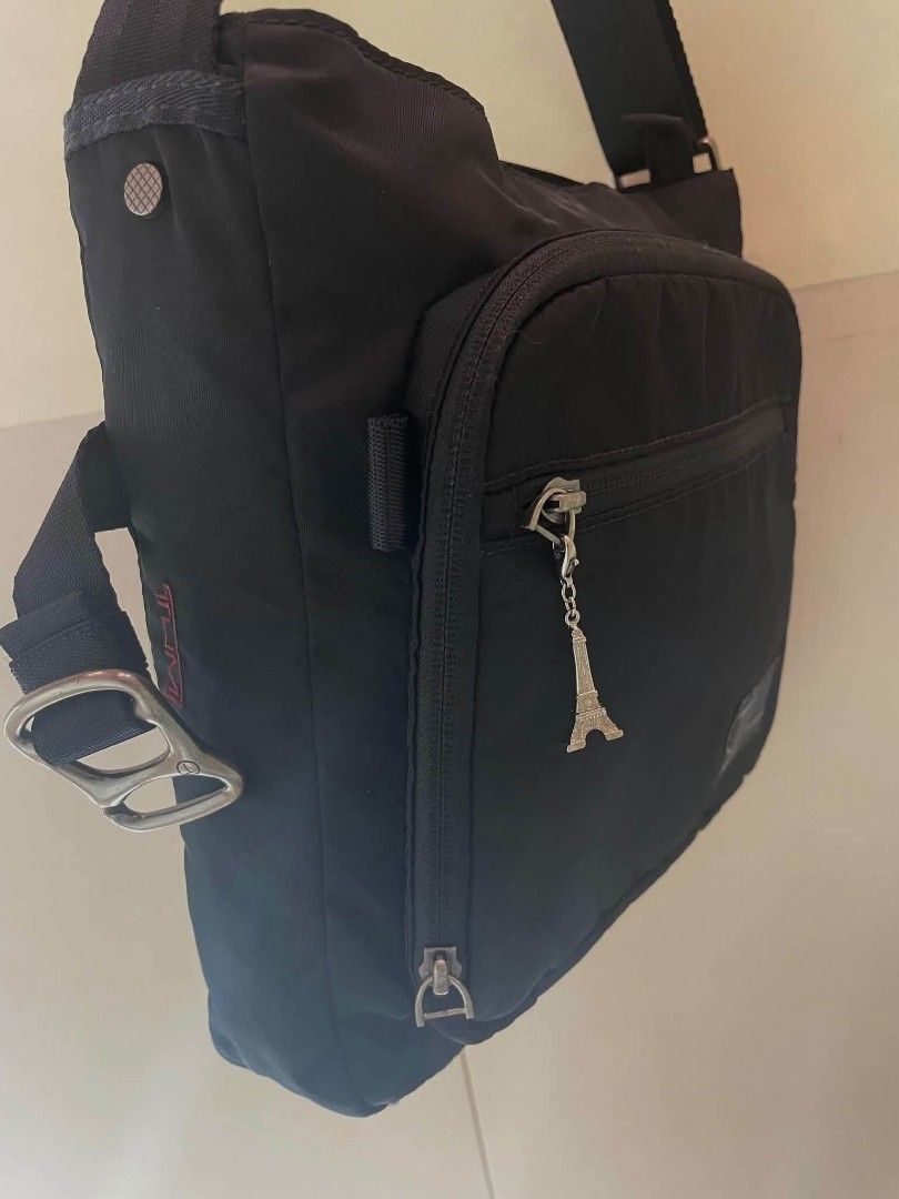 T-Tech black messenger bag (Category: Luxury Bags & Wallets) located in Manila. Submitted by boldfire_315559 (Listing ID 1467641245, Image 3). Description: - Brand: T-Tech - Color: Black - Material: Durable, long-lasting nylon - Strap: Adjustable for a comfortable fit - Hardware: Metal buckle with engraved branding - Pockets: Front zippered pocket with a small hanging charm - Storage: Spacious main compartment ideal for daily carry needs.