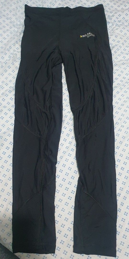 TUNDRA Stretch Leg Warmer (Category: Hiking & Camping) located in Cainta. Submitted by origeetostore (Listing ID 1467632753, Image 1). Description: - Color: Solid black - Fit: Compression style with supportive elastic waistband - Design: Contoured panel stitching down the legs for a flattering fit - Details: Branded logo and distinctive arrow graphics near the left hip - Material: Smooth, flexible athletic fabric - Condition: Brand new / Excellen