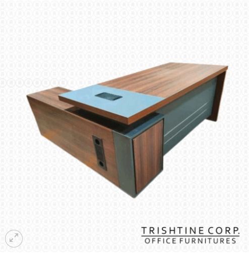 TXT-048 | Executive Table (Category: Office Furniture & Fixtures) located in Caloocan City. Submitted by jim.trishtineofficefurnitures (Listing ID 1467673936, Image 1). Description: - Brand: Trishtine Corp Office Furnitures - Design: L-shape executive desk with wood grain top and dark grey panels - Power & Cables: Built-in power grommet and integrated cable management ports - Storage: Includes a convenient built-in side storage unit - Build: Stur