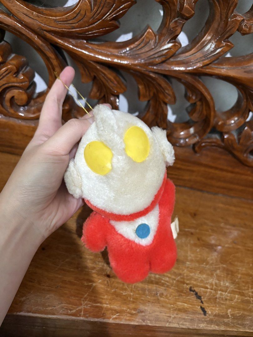 Ultraman plush toy keychain pendant (Category: Plushies & Soft Toys) located in Quezon City. Submitted by rxyel (Listing ID 1467665622, Image 2). Description: - Adorable small Ultraman plush doll with a hanging string - Classic red and white suit design with iconic yellow eyes and blue color timer - Made from soft, high-quality plush fabric - Features an original tag near the bottom back - Perfect accessory for hanging on backpacks, tote bags, or