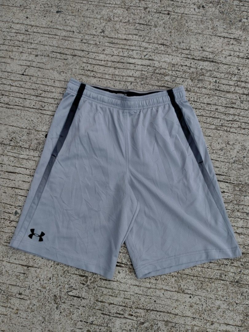 Under Armour Grey Mesh Athletic Shorts Size MD (Category: Shorts) located in Davao. Submitted by ervinpolino09 (Listing ID 1467683734, Image 1). Description: - Brand: Under Armour - Type: Grey mesh athletic shorts - Size: Medium - Fit: Loose fit with elastic waistband and adjustable drawstring - Features: Side pockets and black accent stripes on both legs - Branding: Small black Under Armour logo near bottom hem - Origin: Made in Indonesia.