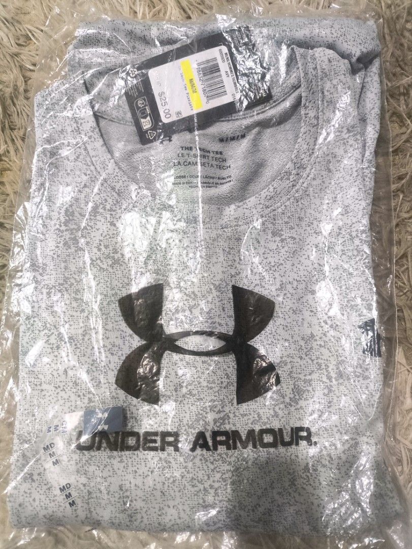 Under Armour Men's Tech Tee Pixelate Grey (Category: Tshirts & Polo Shirts ) located in Rizal. Submitted by youngwolf-5f02 (Listing ID 1467689587, Image 1). Description: - Brand: Under Armour - Item: Tech Tee - Color/Pattern: Grey Pixelate Print - Size: Men's Medium (Loose Fit) - Design: Short sleeves, crew neck, large front logo graphic - Condition: Brand new with original tags, still sealed in plastic packaging - Retail Price: $25.