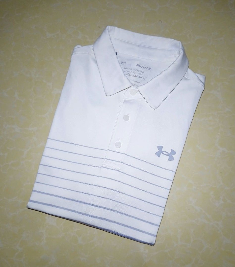 Under Armour The Playoff Polo White Grey Size M (Category: Tshirts & Polo Shirts ) located in Manila. Submitted by purefire-477a (Listing ID 1467769810, Image 3). Description: - Brand: Under Armour - Style: The Playoff Polo - Color: White with grey and dark blue horizontal gradient stripes - Size: M - Measurements: 20 inches chest, 27 inches length - Material/Tech: Loose fit HeatGear fabric - Features: Short sleeves, standard collar, three-button