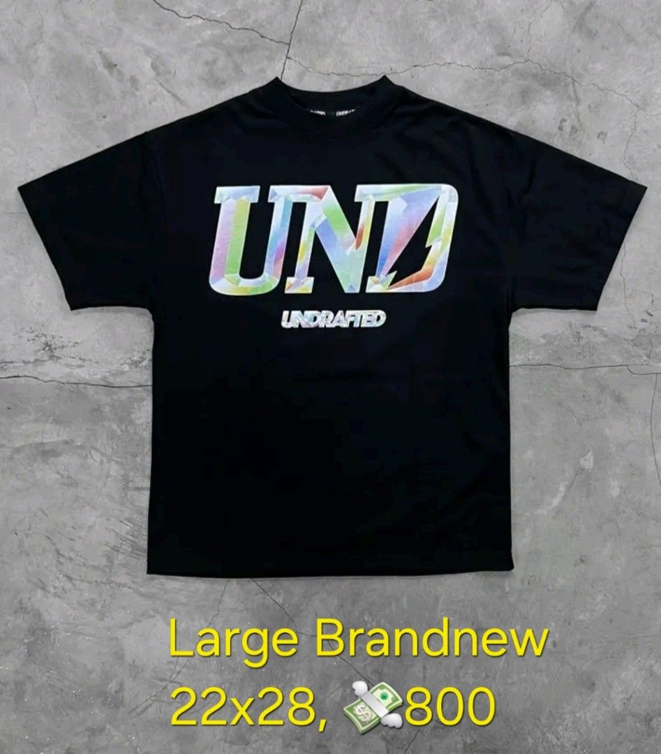 Undrafted UND Large 22x28 (Category: Tshirts & Polo Shirts ) located in Santa Rosa. Submitted by rowhell09 (Listing ID 1467608344, Image 1). Description: Undrafted Large Brandnew 22x28 💸800 MOD. LBC MOP. BDO, GCASH LOC. NUEVA ECIJA Meet up. Santa rosa Nueva Ecija - Condition: Brand new with tags in original plastic packaging - Color: Black with colourful text print across the chest - Fit: Regular fit silhouette - Size: Large - Measurements: Appr