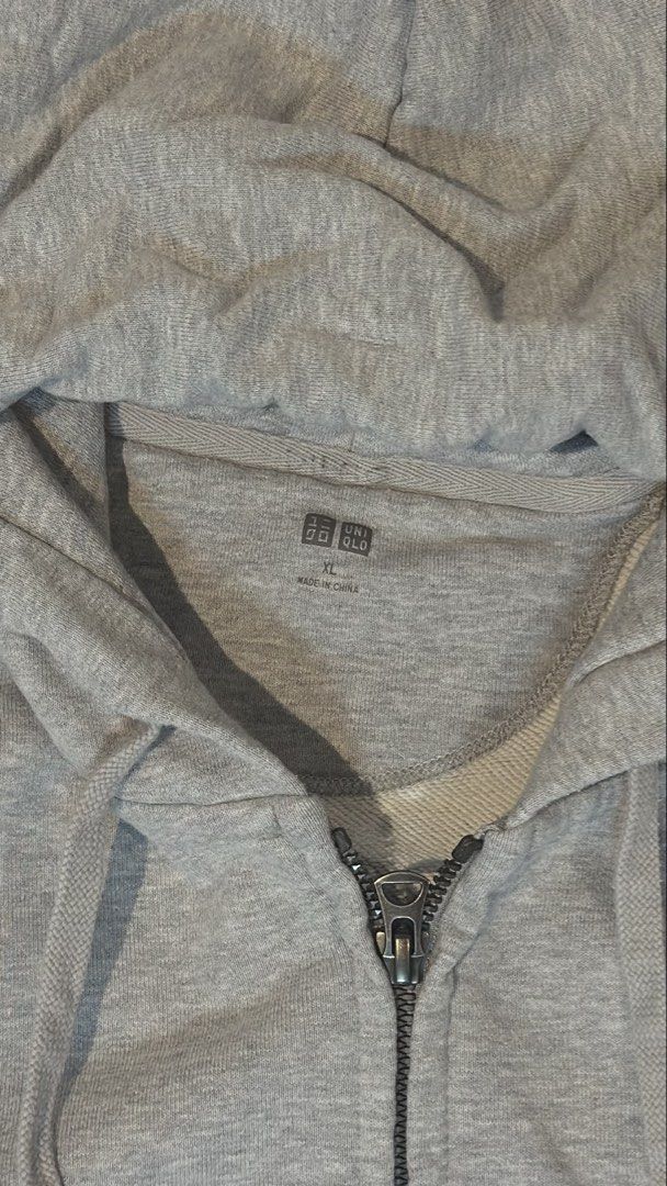 Uniqlo Grey Zip Up (Category: Hoodies) located in Manila. Submitted by royalgem-3655 (Listing ID 1467710043, Image 2). Description: - Brand: Uniqlo - Color: Light Grey - Size: XL (Relaxed fit) - Material: Soft cotton blend - Features: Full front zipper, adjustable drawstring hood, front kangaroo pockets - Condition: Clean and ready to wear.