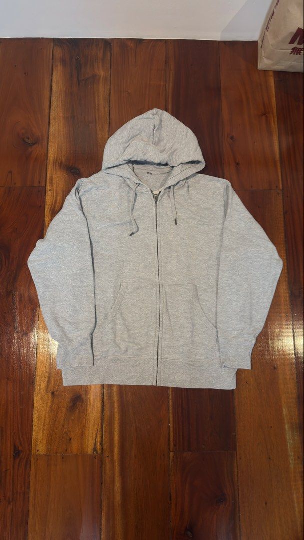 Uniqlo Grey Zip Up (Category: Hoodies) located in Manila. Submitted by royalgem-3655 (Listing ID 1467710043, Image 1). Description: - Brand: Uniqlo - Color: Light Grey - Size: XL (Relaxed fit) - Material: Soft cotton blend - Features: Full front zipper, adjustable drawstring hood, front kangaroo pockets - Condition: Clean and ready to wear.