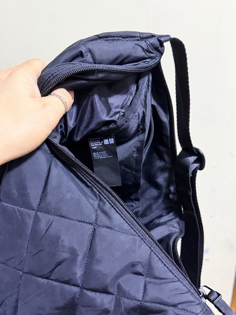 Uniqlo Quilted cresent Shoulder Bag Black (Category: Shoulder Bags) located in Paete. Submitted by skydruemadison (Listing ID 1467719625, Image 3). Description: Black quilted shoulder bag from Uniqlo. Crescent shape with a zipped main compartment and interior pocket. Adjustable strap with buckle. Lightweight nylon material, quilted pattern all over. Spacious inside for daily essentials. Clean interior lining with brand tag attached inside..