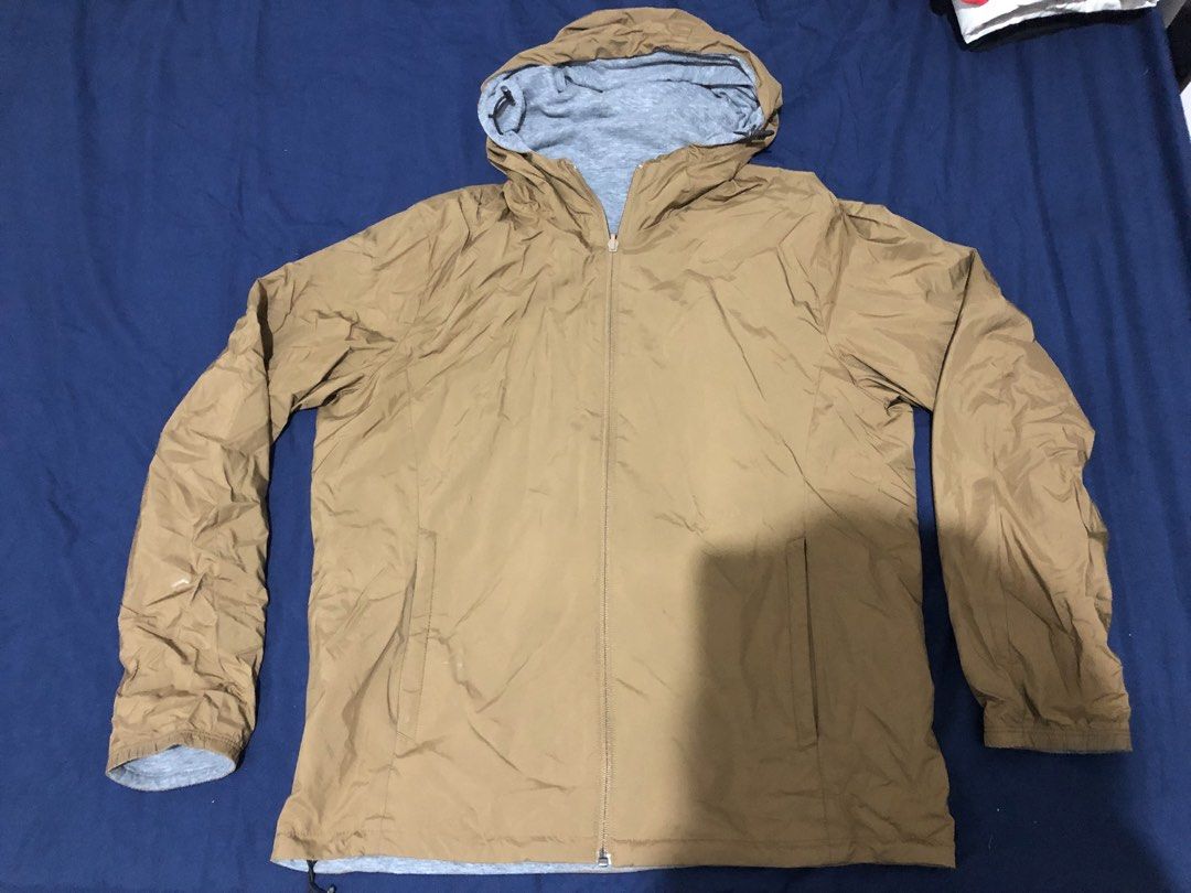 Uniqlo Reversible Brown Grey Hooded Jacket (Category: Coats, Jackets and Outerwear) located in Manila. Submitted by janmichael26601 (Listing ID 1467698509, Image 1). Description: - Two-way design in brown and heather grey - Full zip closure up the front - Attached hood with adjustable drawstrings - Lightweight fabric, ideal for layering - Standard slip pockets on both sides.