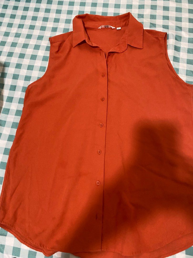 Uniqlo Rust Orange Sleeveless Button-Up Blouse Size L (Category: Sleeveless) located in Cabanatuan. Submitted by ashramtobi29604 (Listing ID 1467724660, Image 2). Description: - Brand: Uniqlo - Style: Sleeveless button-up with classic collar - Color: Rust orange - Size: L (Made in China) - Material: Lightweight and breathable - Condition: Excellent, ideal for layering or warm days Color rate 9/10 almost new.