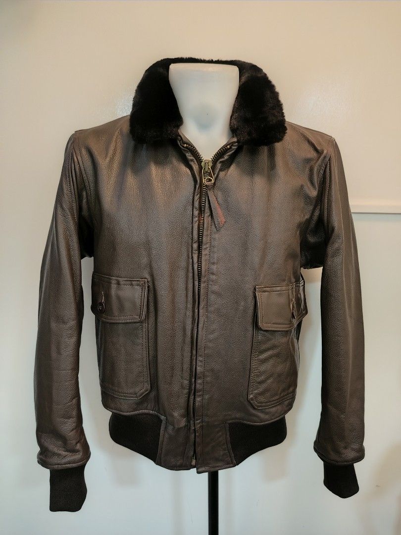 USN Vintage Brown Leather Bomber Jacket (Category: Coats, Jackets and Outerwear) located in La Trinidad. Submitted by padasem_kadi (Listing ID 1467644714, Image 3). Description: - Material: Genuine brown leather with natural texture and grain - Collar: Contrast black fur collar - Closure: Heavy-duty Scovill front zipper - Pockets: Two front flap pockets with button closure - Details: Ribbed cuffs and hem for a classic bomber fit - Measurements: 2