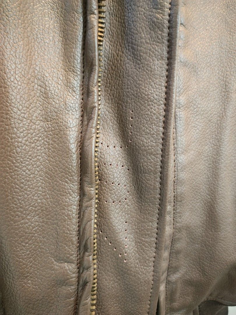 USN Vintage Brown Leather Bomber Jacket (Category: Coats, Jackets and Outerwear) located in La Trinidad. Submitted by padasem_kadi (Listing ID 1467644714, Image 2). Description: - Material: Genuine brown leather with natural texture and grain - Collar: Contrast black fur collar - Closure: Heavy-duty Scovill front zipper - Pockets: Two front flap pockets with button closure - Details: Ribbed cuffs and hem for a classic bomber fit - Measurements: 2