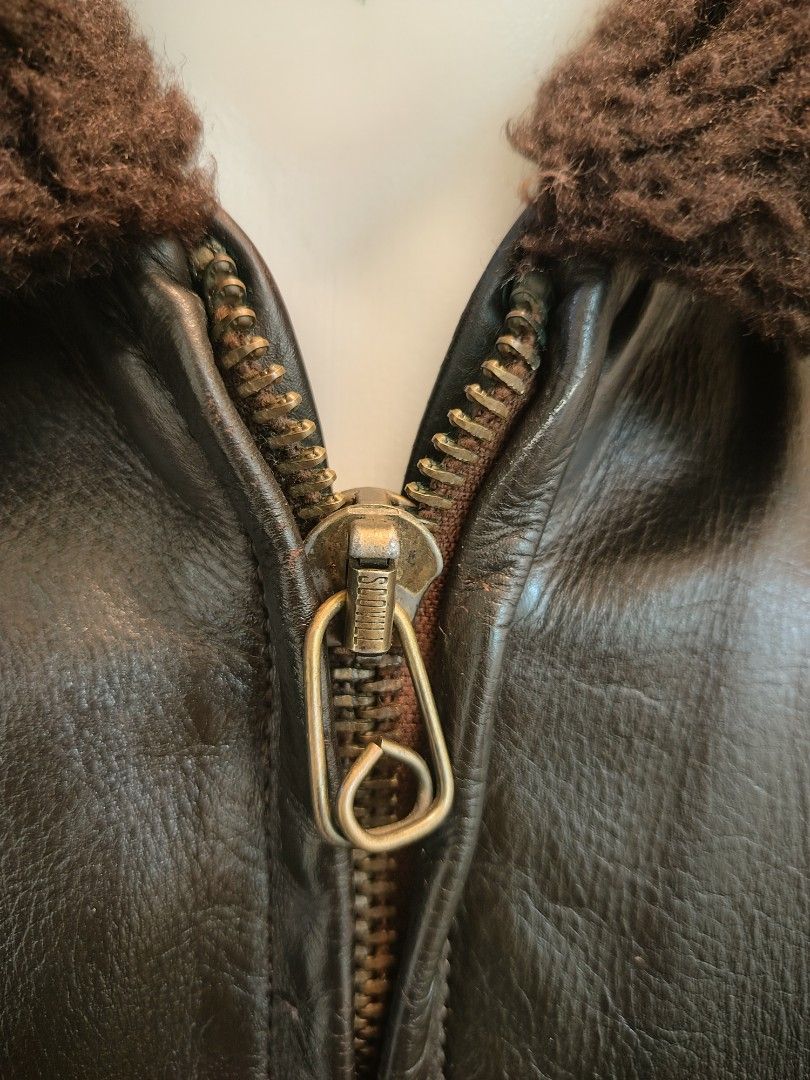 USN Vintage Leather Bomber Jacket with Shearling Collar (Category: Coats, Jackets and Outerwear) located in La Trinidad. Submitted by padasem_kadi (Listing ID 1467643899, Image 3). Description: Genuine leather bomber jacket in dark brown. Plush brown shearling collar. Ribbed cuffs and hem keep the wind out. Heavy-duty Scovill zipper works smoothly. Dual front flap pockets with button closures. Chest measures 21.5 inches, length is 24.5 inches, an
