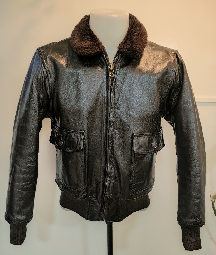 USN Vintage Leather Bomber Jacket with Shearling Collar (Category: Coats, Jackets and Outerwear) located in La Trinidad. Submitted by padasem_kadi (Listing ID 1467643899, Image 2). Description: Genuine leather bomber jacket in dark brown. Plush brown shearling collar. Ribbed cuffs and hem keep the wind out. Heavy-duty Scovill zipper works smoothly. Dual front flap pockets with button closures. Chest measures 21.5 inches, length is 24.5 inches, an