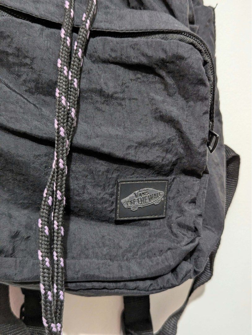 Vans Black Drawstring Backpack (Category: Backpacks) located in Quezon City. Submitted by thegoodkarmaph (Listing ID 1467721145, Image 3). Description: Black nylon backpack from Vans. Drawstring closure with patterned rope cord. Front zippered pocket features the rubberized Off The Wall patch logo. Inside has black checkered lining and a Vans woven tag. Adjustable shoulder straps in matching black webbing. Handy side slip pockets too. Great daily