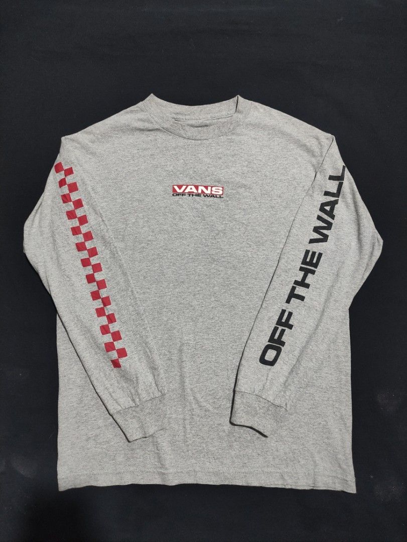Vans Off The Wall Long Sleeve Tee Grey (Category: Tshirts & Polo Shirts ) located in Binan City. Submitted by mmrl_rmwl00 (Listing ID 1467794704, Image 1). Description: - Brand: Vans -Dimes: 20.5x27 - Color: Grey with red and black graphic details - Material: 100% Cotton, made in Mexico - Design: Red checkered pattern on right sleeve, 'Off The Wall' text on left sleeve, and chest box logo - Fit: Classic crew neck - Care: Machine washable.