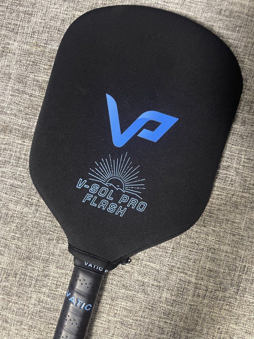 Vatic Pro Flash 16mm Pickleball Paddle V-Sol Pro (Category: Racket and Ball Sports) located in Cordon. Submitted by secondgreatt (Listing ID 1467762521, Image 2). Description: - Brand: Vatic Pro Flash Pickleball Paddle - Thickness: 16mm with foam core construction for power and control - Face: Black carbon fiber with striking blue branding and text accents - Handle: Standard length wrapped in a comfortable perforated black grip tape - Inclusion: 