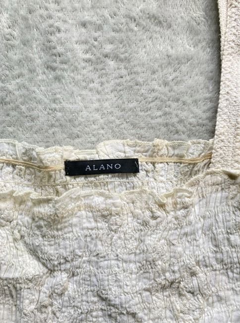Vintage White Smocked Top (Category: Sleeveless) located in Rizal. Submitted by sheeraay (Listing ID 1467662238, Image 3). Description: - Brand: ALANO - Color: White - Style: Crop top with all-over smocking texture and square neckline - Features: Wide straps, cute ruffle trim, and stretchy crinkled fabric - Fit: Easy to pair with high-waisted jeans, skirts, or shorts.