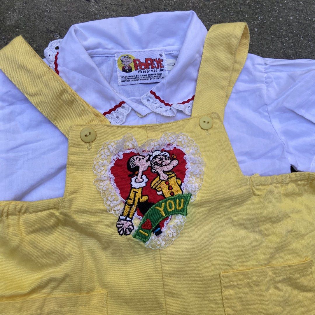 Vintage 1991 Popeye Overall Embroidery Patch (Category: Babies & Kids Fashion) located in Angeles City. Submitted by eriellynnthrifts (Listing ID 1467732502, Image 2). Description: This is a vintage children’s two-piece outfit featuring a yellow short-all overall paired with a white collared blouse featuring Popeye branding on the tag (licensed by King Features Syndicate) and an embroidered Popeye and Olive Oyl “I Love You” heart graphic on the c