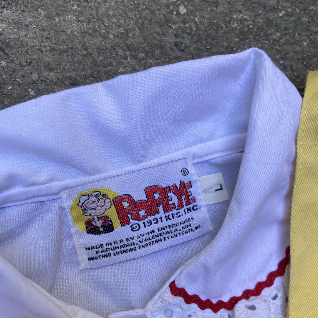 Vintage 1991 Popeye Overall Embroidery Patch (Category: Babies & Kids Fashion) located in Angeles City. Submitted by eriellynnthrifts (Listing ID 1467732502, Image 3). Description: This is a vintage children’s two-piece outfit featuring a yellow short-all overall paired with a white collared blouse featuring Popeye branding on the tag (licensed by King Features Syndicate) and an embroidered Popeye and Olive Oyl “I Love You” heart graphic on the c