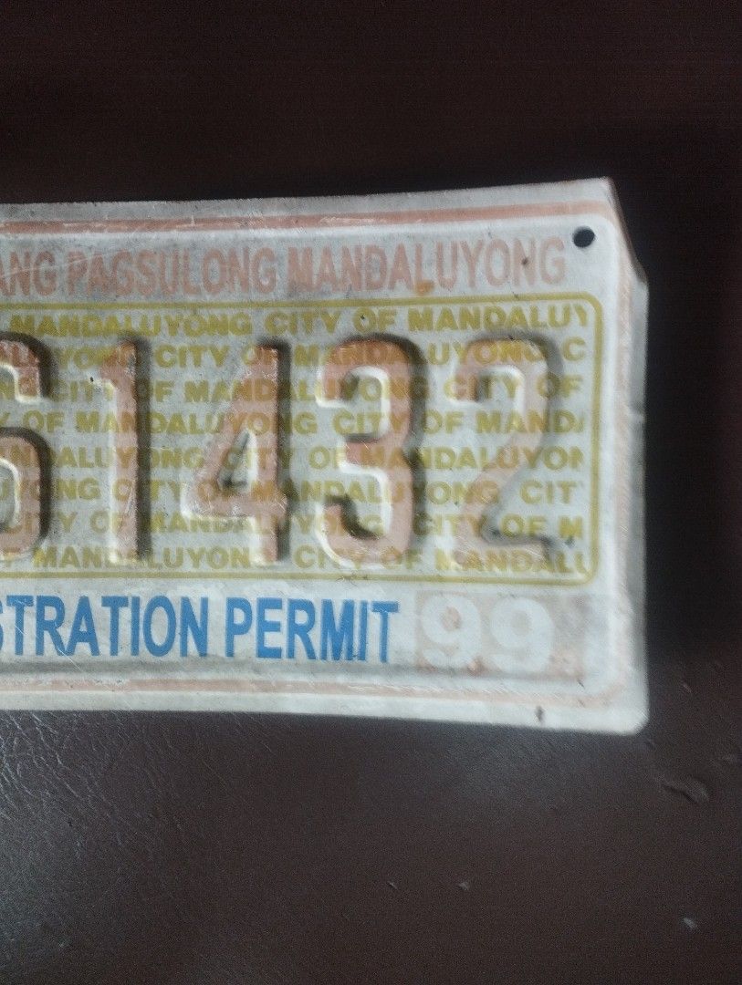 VINTAGE BUSINESS PERMIT 1990S ERA (Category: Tshirts & Polo Shirts ) located in Mandaluyong City. Submitted by LEATHERFACE (Listing ID 1467609613, Image 2). Description: - Authentic vintage business registration permit plate from Mandaluyong City - Issued in the year 1999 (Plate No: S1432) - Features official seal on the left side with classic white and blue lettering - Includes mounting holes on both ends for easy display - Exhibits natural sign